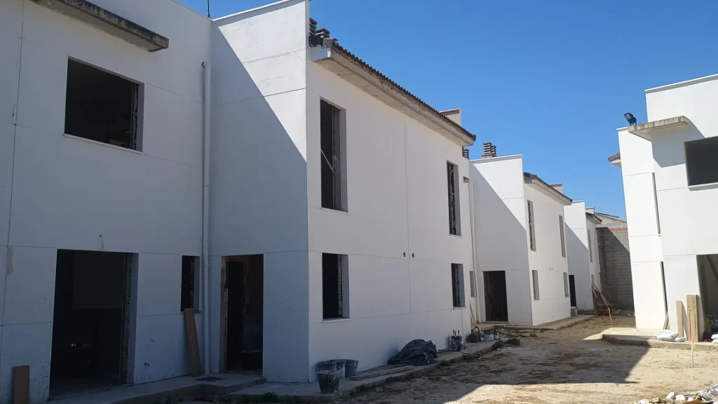 Viviendas unifamiliares de fachada blanca recién terminadas
